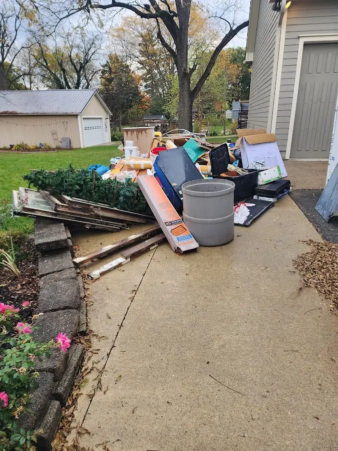 Dumpster being loaded with debris for 10 Yard Dumpster Rental in Hampden